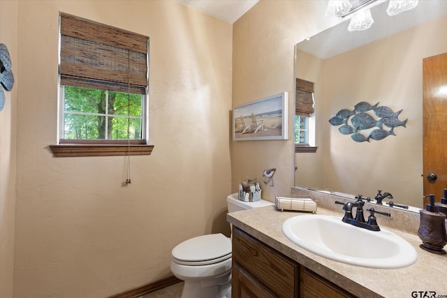 408 E Forest Dr, White Oak, TX 75693 - bathroom with healthy amount of natural light, toilet, and vanity
