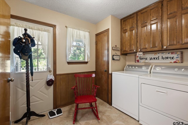 408 E Forest Dr, White Oak, TX 75693 - washroom featuring cabinet space, washing machine and clothes dryer, a textured ceiling, and wainscoting
