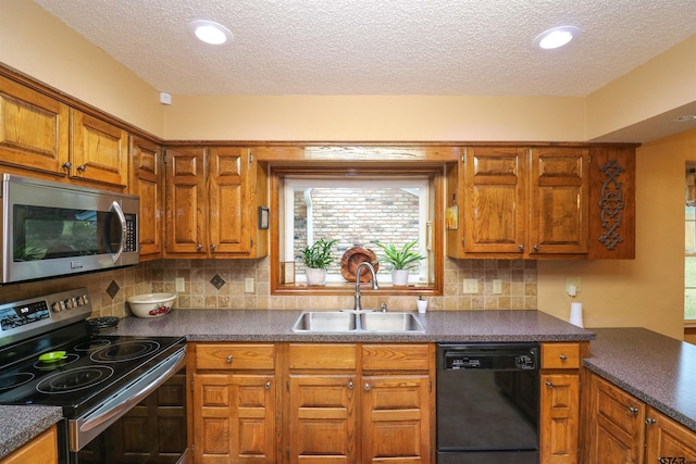 kitchen featuring appliances with stainless steel finishes, sink, a textured ceiling, and decorative backsplash