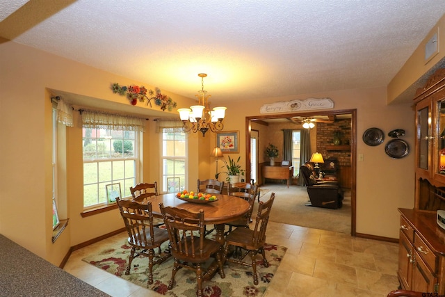 dining space featuring a textured ceiling and a notable chandelier