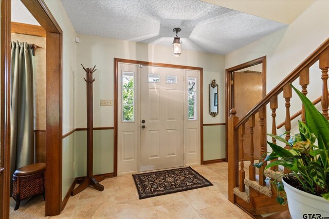 408 E Forest Dr, White Oak, TX 75693 - entryway with a textured ceiling, stairs, and baseboards