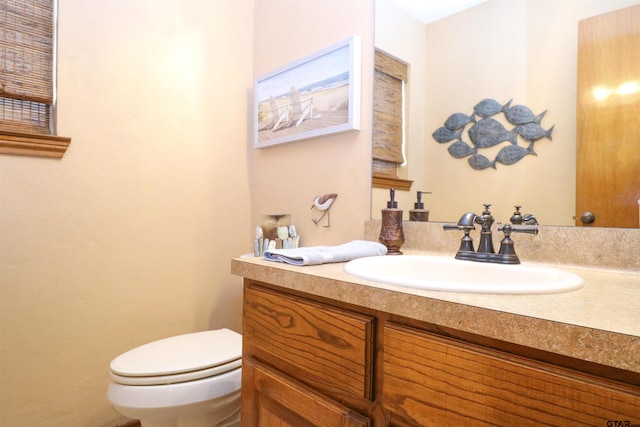 bathroom with vanity and toilet