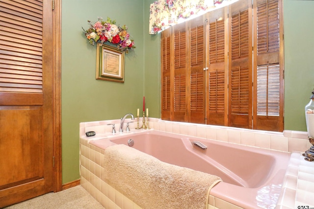 bathroom with a relaxing tiled tub