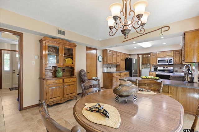 408 E Forest Dr, White Oak, TX 75693 - dining space featuring a chandelier and baseboards