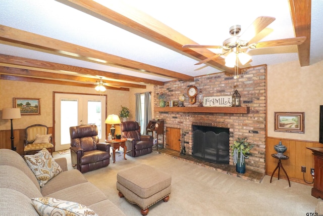 living room with light colored carpet, a fireplace, beam ceiling, and french doors