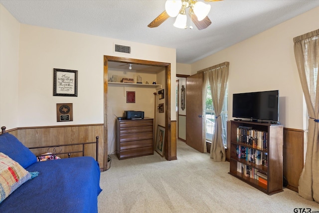 408 E Forest Dr, White Oak, TX 75693 - bedroom featuring carpet floors, wainscoting, ceiling fan, and wooden walls