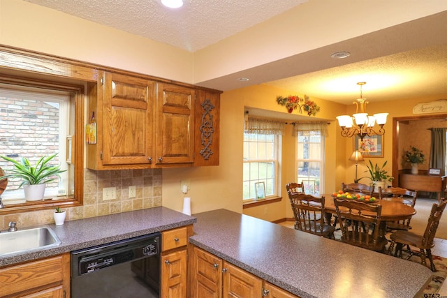 kitchen featuring pendant lighting, dishwasher, decorative backsplash, and a textured ceiling