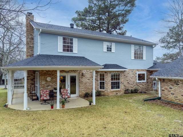 back of property with a patio and a lawn