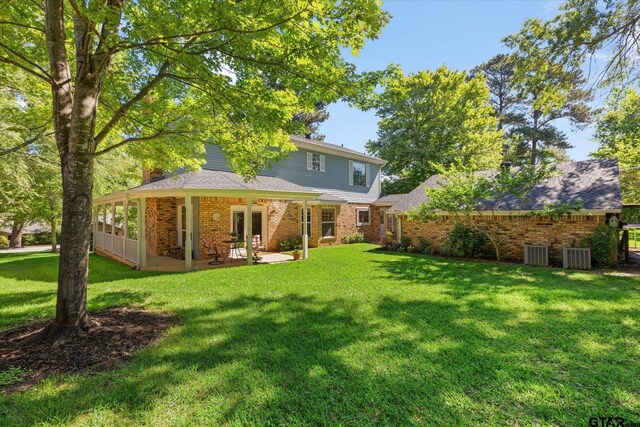 408 E Forest Dr, White Oak, TX 75693 - back of house with a yard, brick siding, and central air condition unit