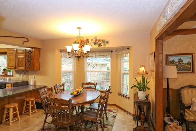 dining room with light tile patterned floors, a textured ceiling, a chandelier, and a healthy amount of sunlight