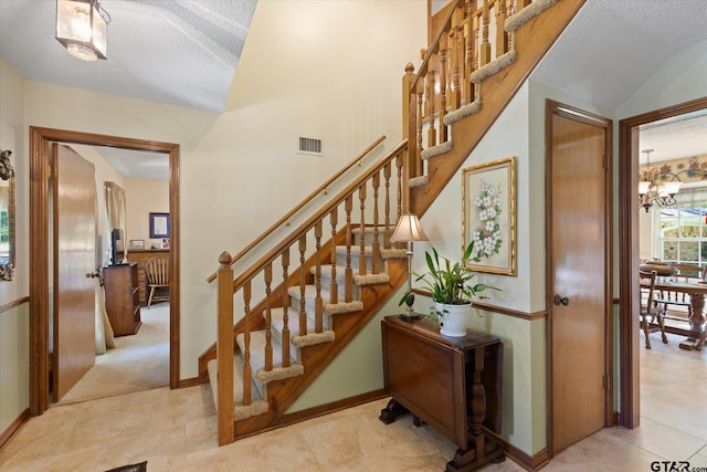 408 E Forest Dr, White Oak, TX 75693 - staircase with a textured ceiling, a chandelier, baseboards, and lofted ceiling