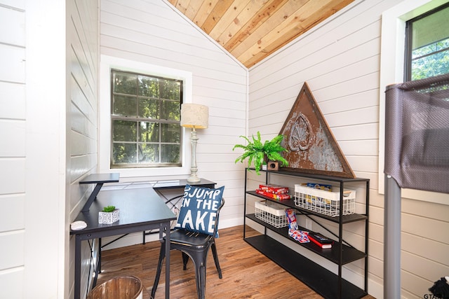 office area featuring lofted ceiling, hardwood / wood-style floors, wood ceiling, and wood walls