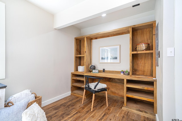 office space featuring built in desk and dark hardwood / wood-style flooring