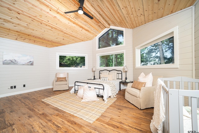 bedroom featuring wood ceiling, lofted ceiling, multiple windows, and hardwood / wood-style flooring