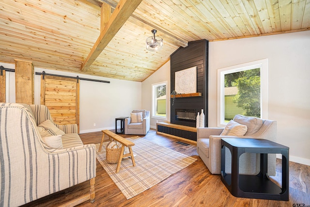 living room with wooden ceiling, a barn door, and a wealth of natural light