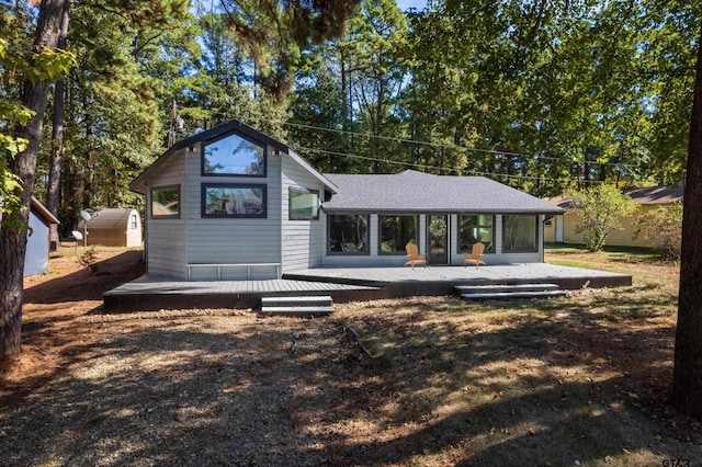 back of house with a wooden deck and a yard