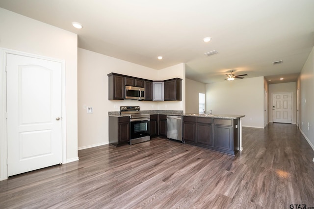 1439 Monterey Dr, Longview, TX 75601 - kitchen featuring stainless steel appliances, ceiling fan, dark wood-style flooring, dark brown cabinets, and recessed lighting