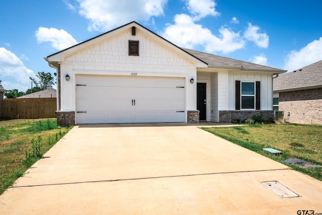 1439 Monterey Dr, Longview, TX 75601 - view of front of property with driveway, a garage, and stone siding