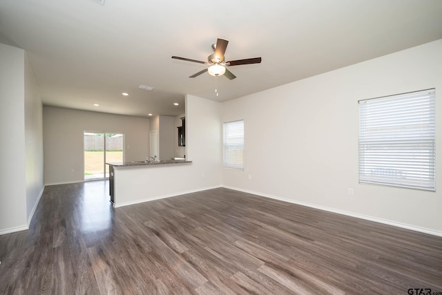 1439 Monterey Dr, Longview, TX 75601 - unfurnished living room with a ceiling fan, dark wood-style flooring, and recessed lighting