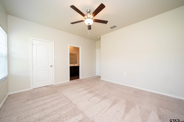 1439 Monterey Dr, Longview, TX 75601 - unfurnished bedroom with carpet flooring, connected bathroom, and ceiling fan