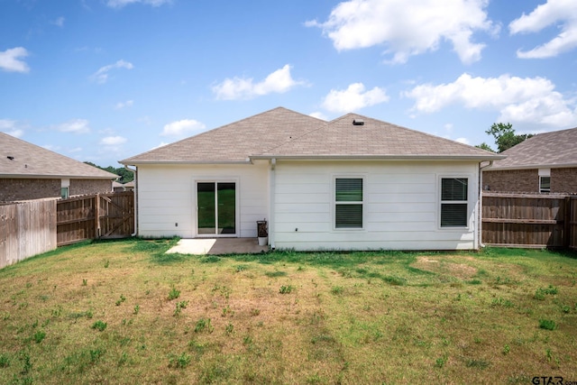 1439 Monterey Dr, Longview, TX 75601 - rear view of property featuring a fenced backyard, a patio, and a shingled roof
