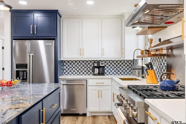 kitchen with white cabinets, high quality appliances, blue cabinets, and range hood