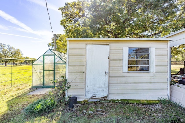 view of outbuilding featuring a lawn