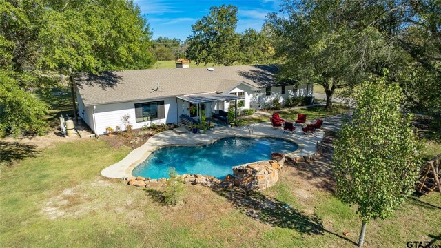 view of swimming pool with a yard and a patio area