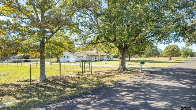 exterior space featuring a front lawn and a rural view