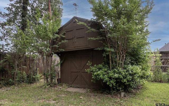view of shed with fence