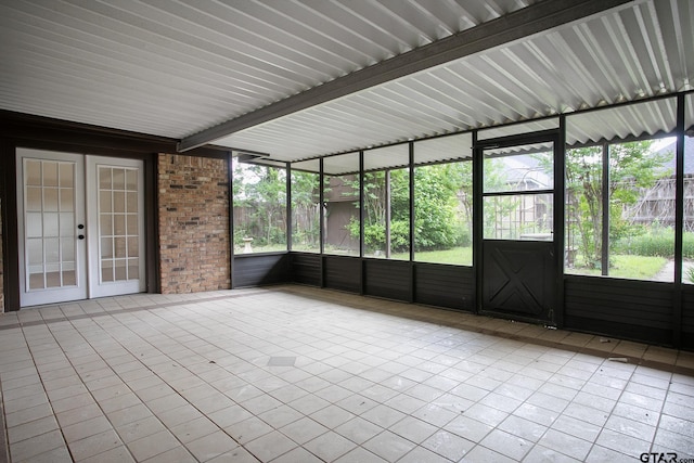 unfurnished sunroom with french doors and a wealth of natural light