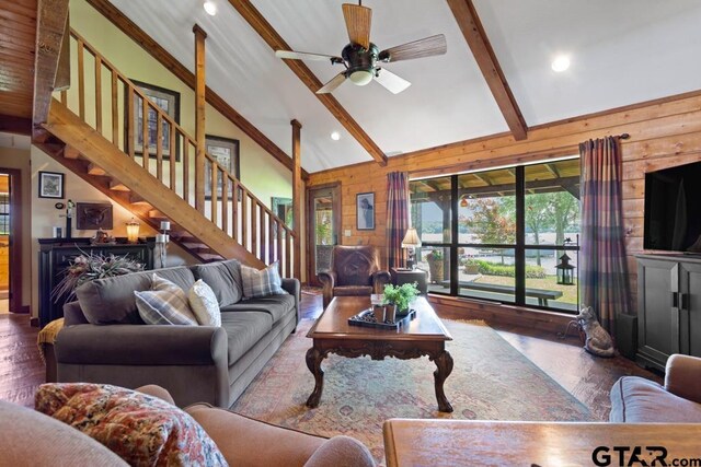 16887 Rainbow Ridge Cir, Tyler, TX 75707 - living area with wooden walls, high vaulted ceiling, beam ceiling, wood finished floors, and stairs