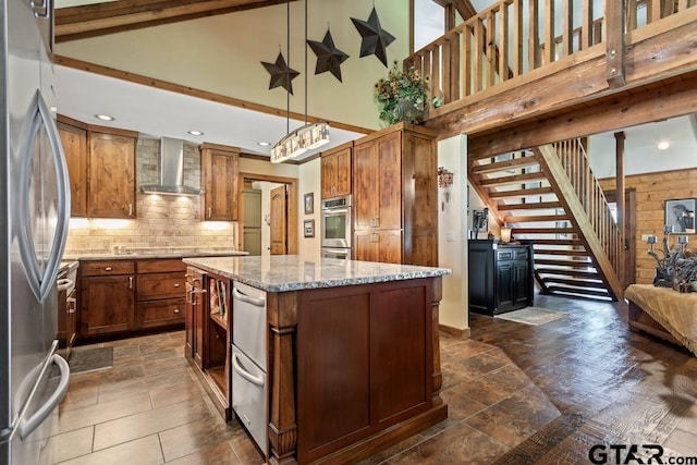 16887 Rainbow Ridge Cir, Tyler, TX 75707 - kitchen featuring wall chimney range hood, appliances with stainless steel finishes, high vaulted ceiling, a kitchen island, and tasteful backsplash