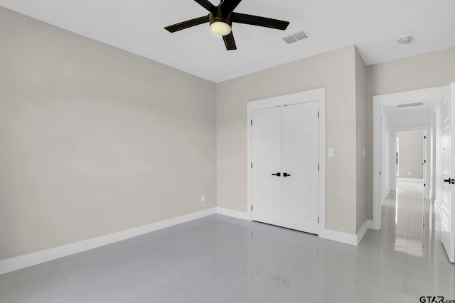 unfurnished bedroom with ceiling fan, a closet, and light tile patterned flooring