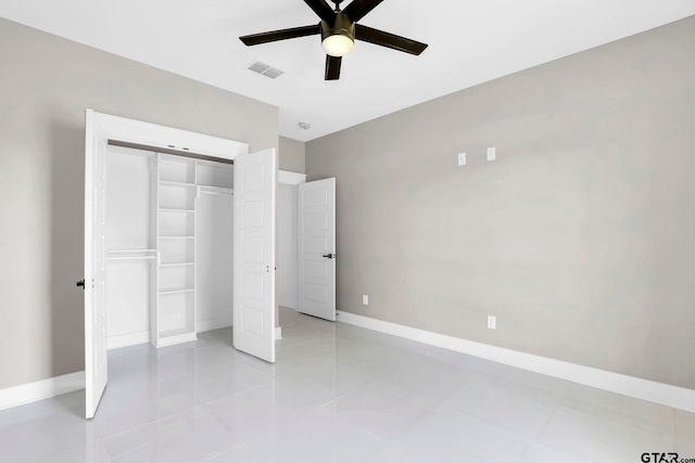 unfurnished bedroom with ceiling fan, light tile patterned flooring, and a closet