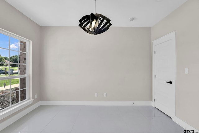 unfurnished room featuring light tile patterned floors and a wealth of natural light