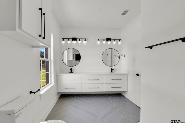 bathroom featuring vanity and toilet