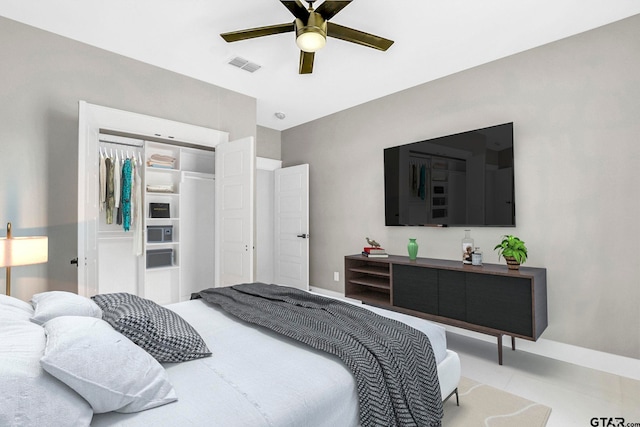 tiled bedroom with a closet and ceiling fan