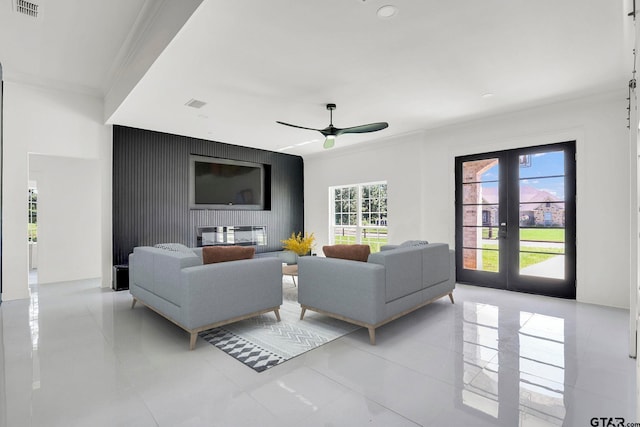 living room with ceiling fan, ornamental molding, light tile patterned floors, and french doors