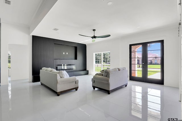 living room featuring french doors, ceiling fan, and crown molding