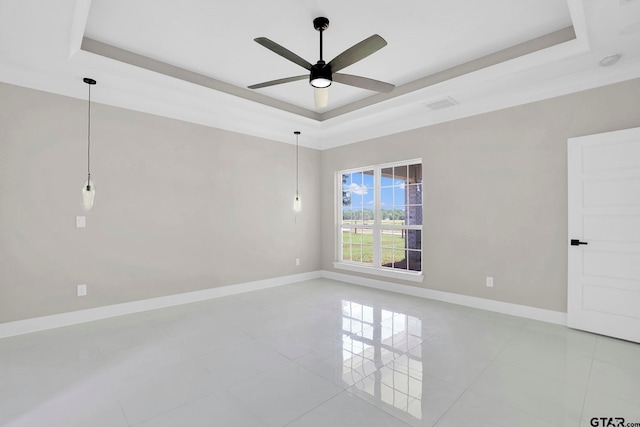 unfurnished room with a tray ceiling and ceiling fan