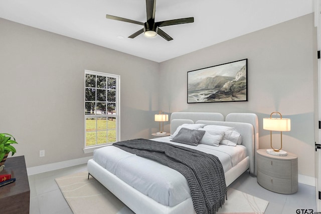 bedroom with ceiling fan and light tile patterned flooring