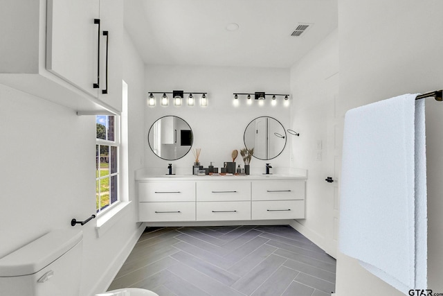 bathroom featuring vanity and toilet