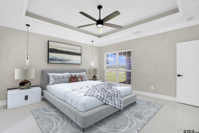 bedroom featuring a tray ceiling and ceiling fan