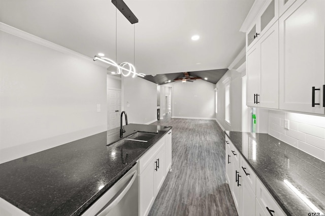 kitchen featuring hanging light fixtures, sink, and white cabinets