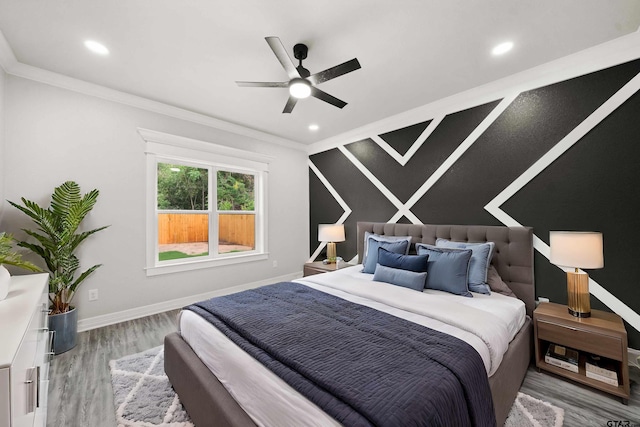 bedroom with hardwood / wood-style floors, ceiling fan, and crown molding