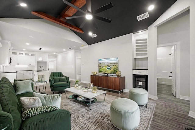 living room with a fireplace, high vaulted ceiling, hardwood / wood-style flooring, beamed ceiling, and ceiling fan