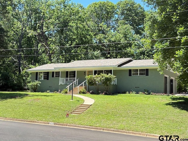 1113 Swanson Dr, Palestine, TX 75801 - ranch-style home featuring a porch, a front yard, and an attached garage