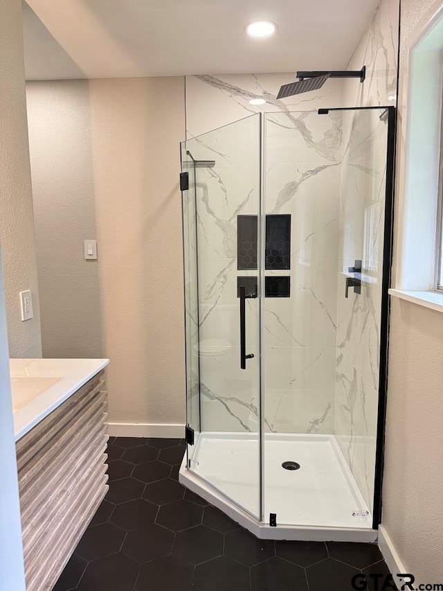 1113 Swanson Dr, Palestine, TX 75801 - full bath featuring a marble finish shower, baseboards, tile patterned floors, vanity, and recessed lighting
