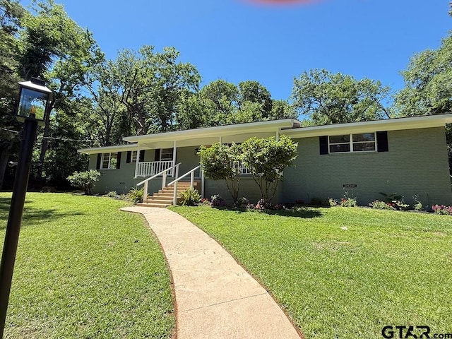 1113 Swanson Dr, Palestine, TX 75801 - view of front of property with a front lawn, covered porch, and brick siding
